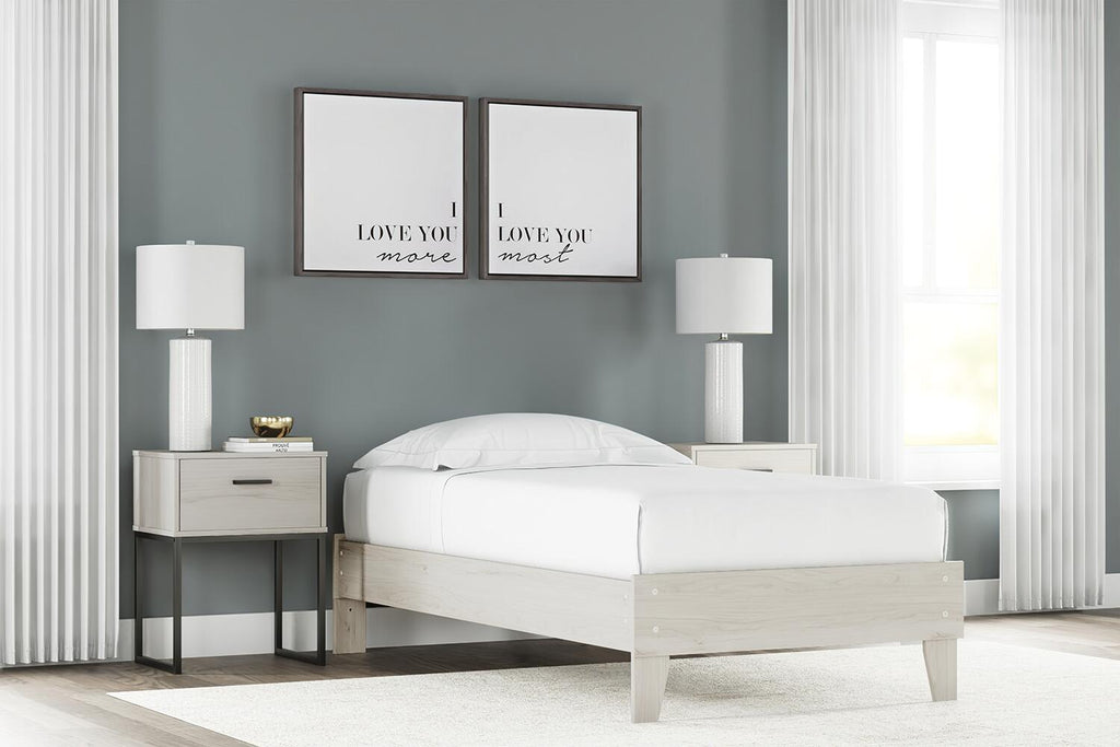 Platform bed with light wood frame and white mattress, smooth panels and slatted base