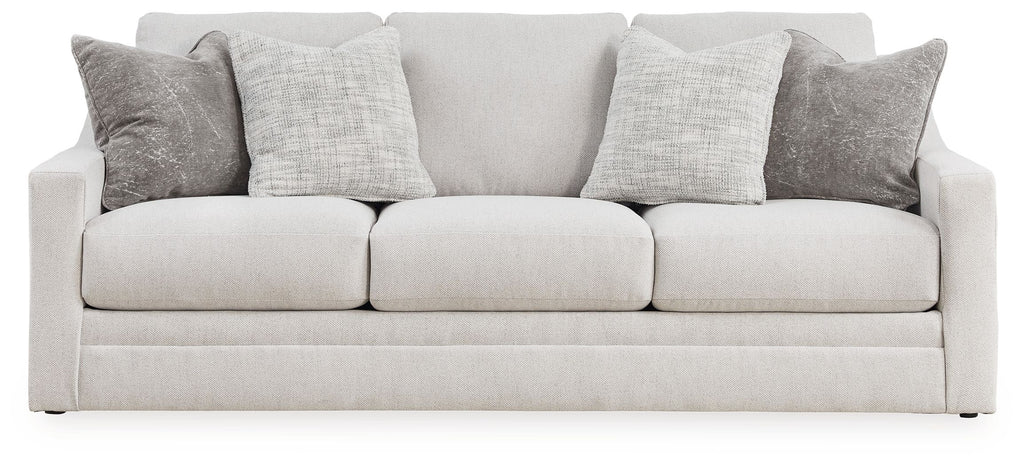 Light gray sofa with three seat cushions and multiple gray back pillows