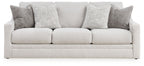 Light gray sofa with three seat cushions and multiple gray back pillows