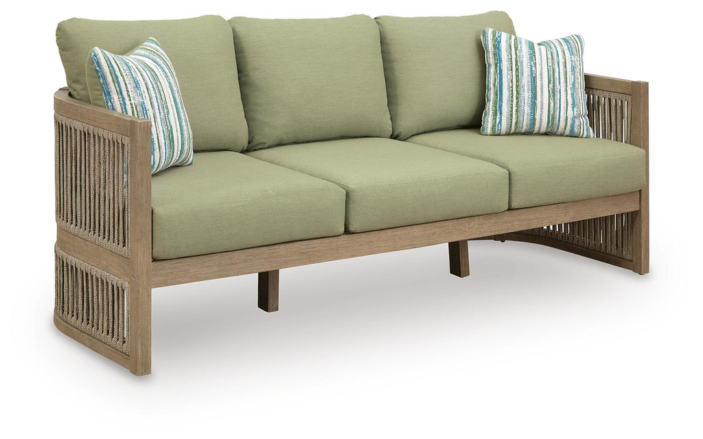 Beige sofa with green seat cushions and striped throw pillows