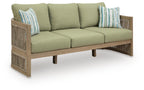 Beige sofa with green seat cushions and striped throw pillows