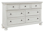 Antique white dresser with six drawers and round knob pulls in three top and three bottom.