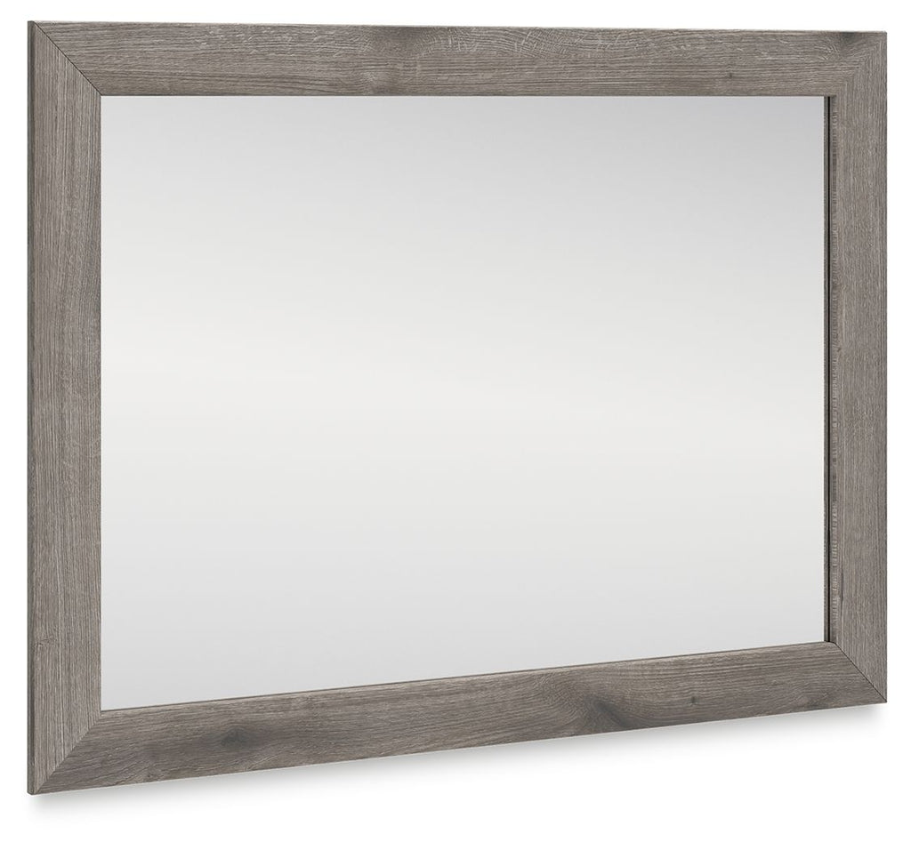 Rectangular bedroom mirror with gray-brown distressed frame and clear glass