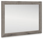 Rectangular bedroom mirror with gray-brown distressed frame and clear glass