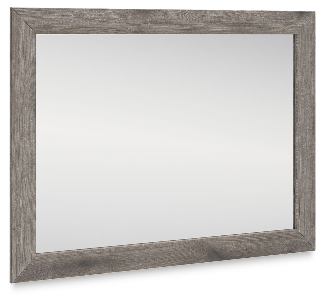 Rectangular bedroom mirror with gray-brown distressed frame and clear glass
