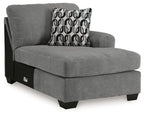 Gray upholstered corner chaise with patterned back cushion