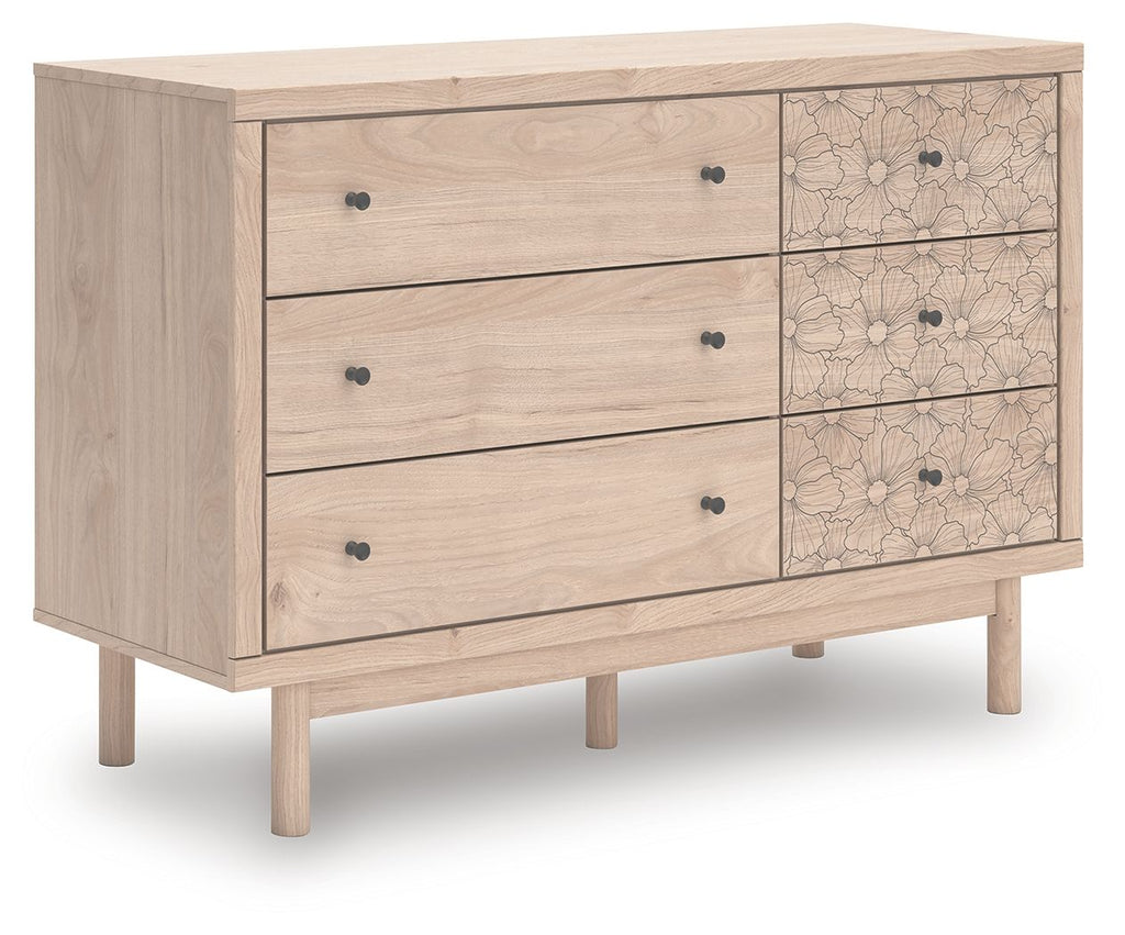 Wood dresser with three drawers and floral-pattern cabinet fronts, dark knobs