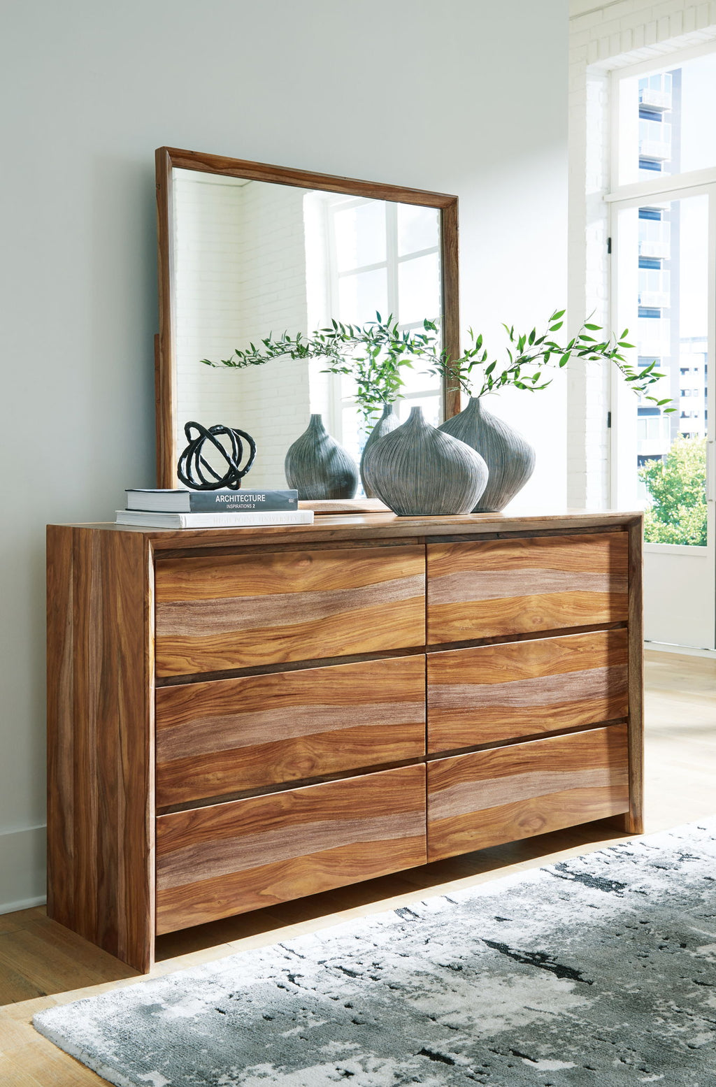Light brown wood dresser with 6 drawers and tall framed mirror above