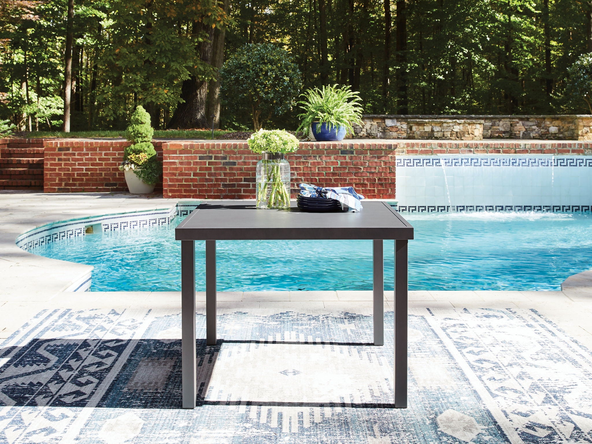 Gray square outdoor dining table with smooth top and four straight legs