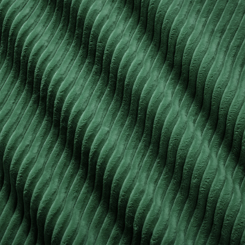 Green corduroy fabric close-up with dense ridged texture
