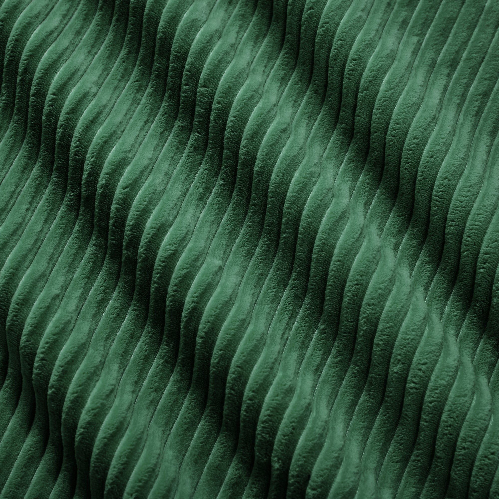 Green corduroy fabric close-up with dense ridged texture