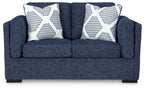 Blue loveseat sofa with two white-and-blue striped throw pillows