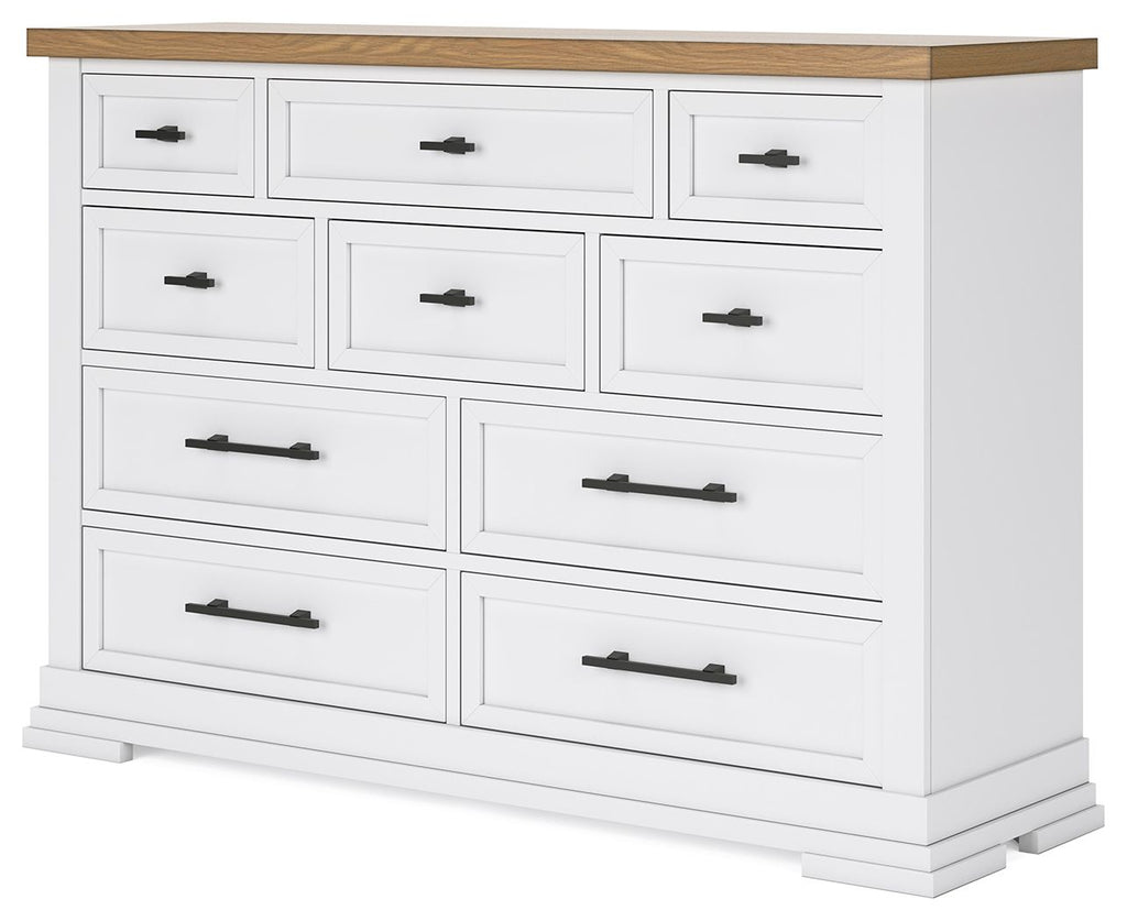 White dresser with black bar handles and natural wood top, multi-drawer front.
