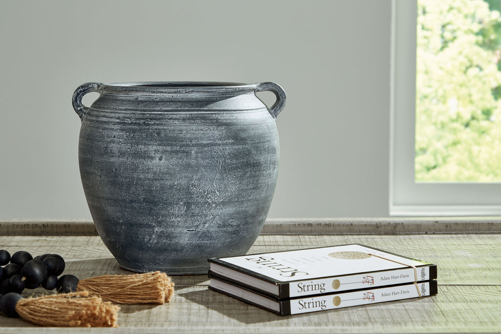 Dark gray ceramic vase with wide mouth and curved side handles, textured finish