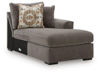 Gray right-arm facing corner chaise with patterned throw pillow and sturdy wooden legs