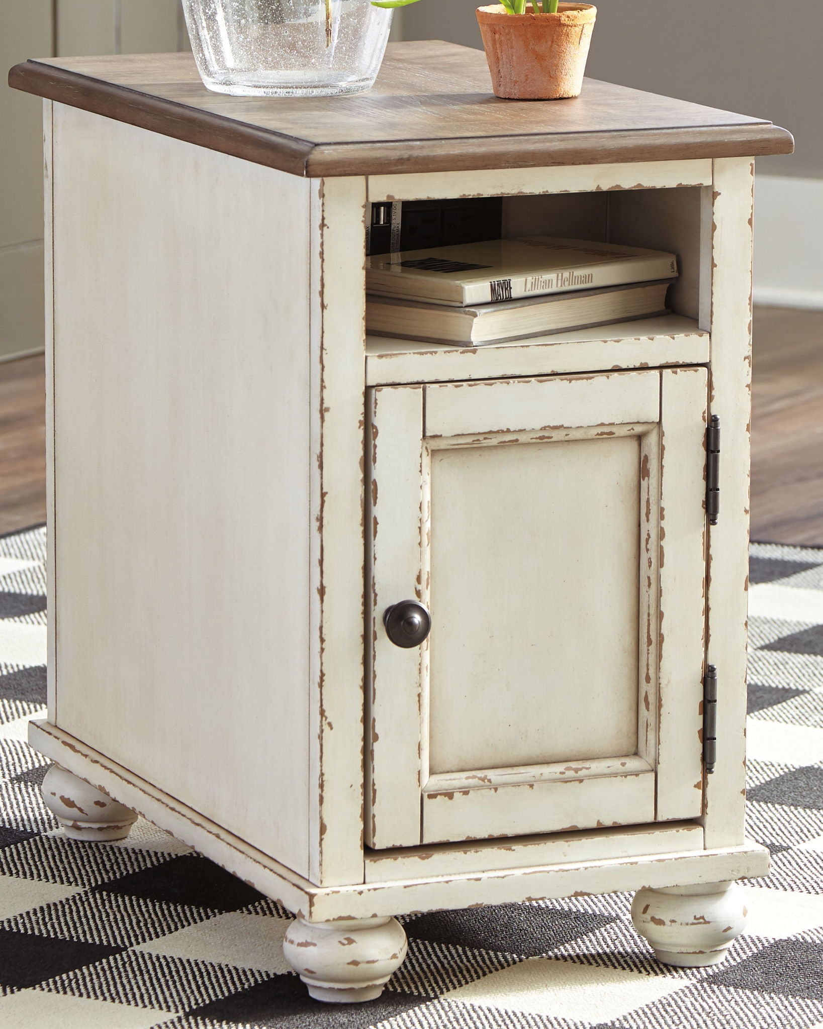 White chair side end table with dark brown top, open shelf under cabinet door