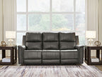 Gray power reclining sofa with three padded headrests and deep seat cushions