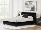 Upholstered bed with black ribbed frame, white comforter and dark decorative pillow