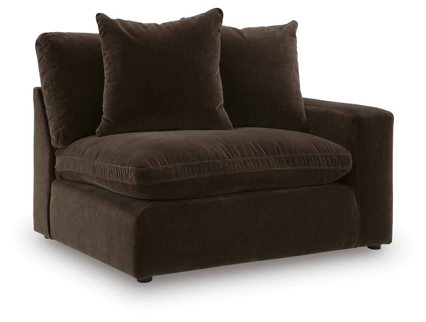 Dark brown upholstered corner chair with three padded back cushions and armrest