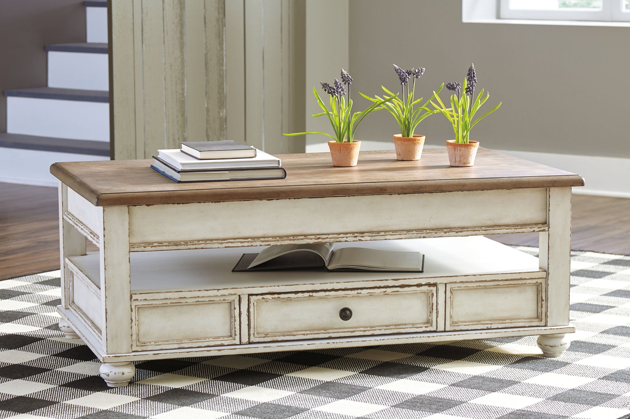 Lift-top cocktail table with dark wood top, white base, front drawer, angled legs.