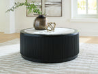 Black ribbed round coffee table with white marble-look top and dark rim