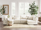 Vanilla sectional sofa with chaise corner, stacked cushions, and layered decorative pillows