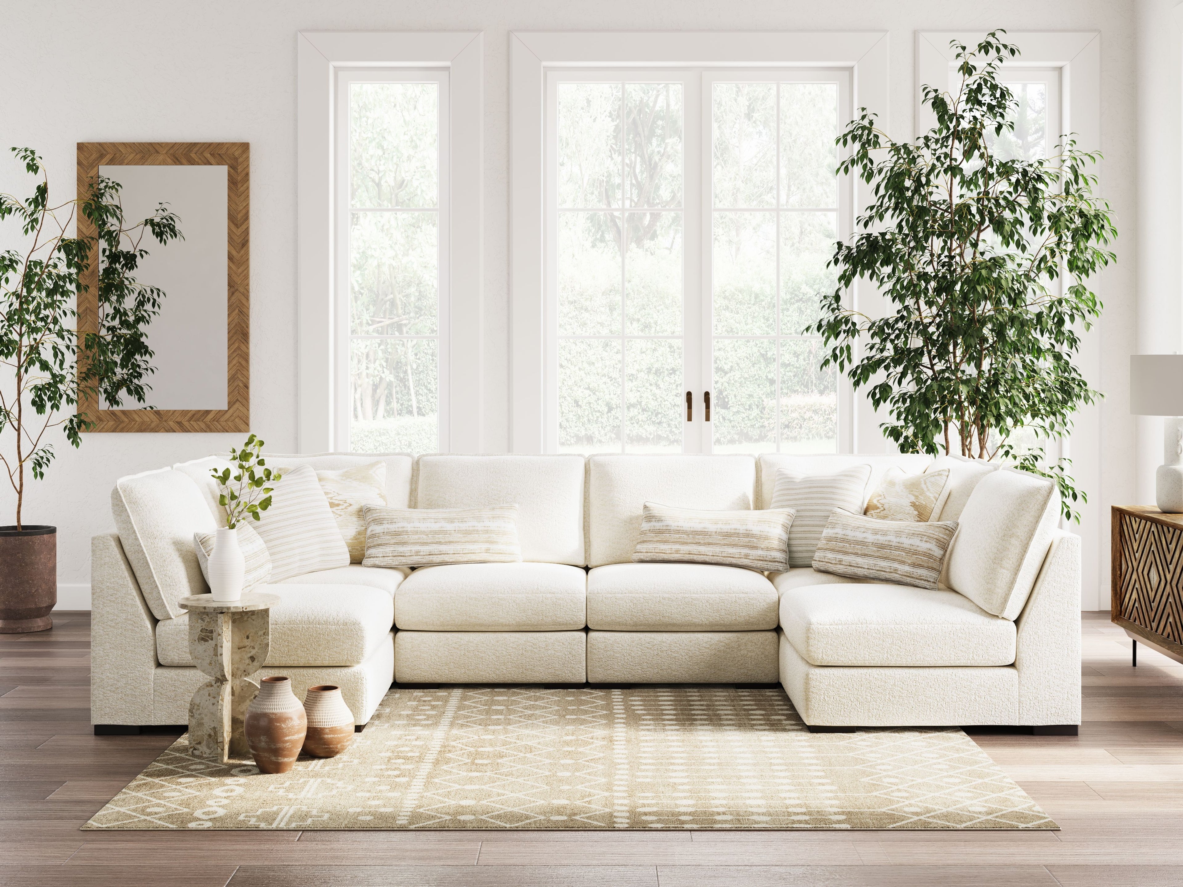 Vanilla sectional sofa with chaise corner, stacked cushions, and layered decorative pillows
