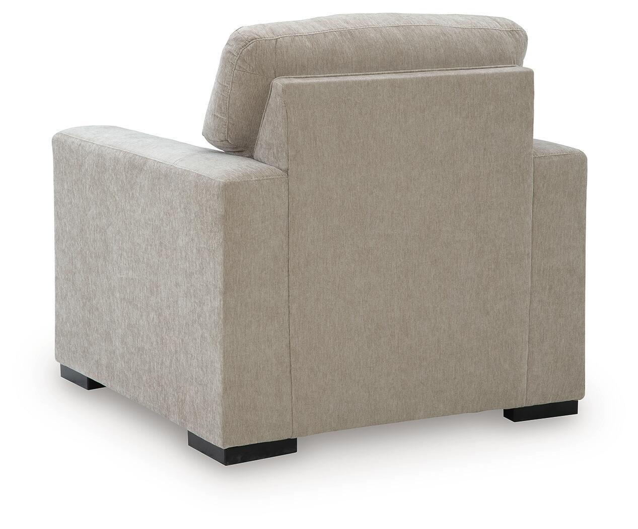 Light gray upholstered armchair rear view with padded headrest and armrests