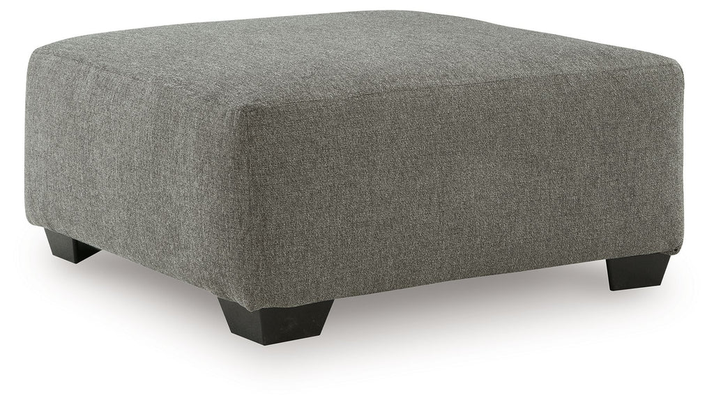 Oversized heathered gray ottoman with dark wooden legs and padded top