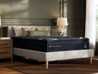 DreamCloud Luxe hybrid mattress on bed with blue quilted top and dark base