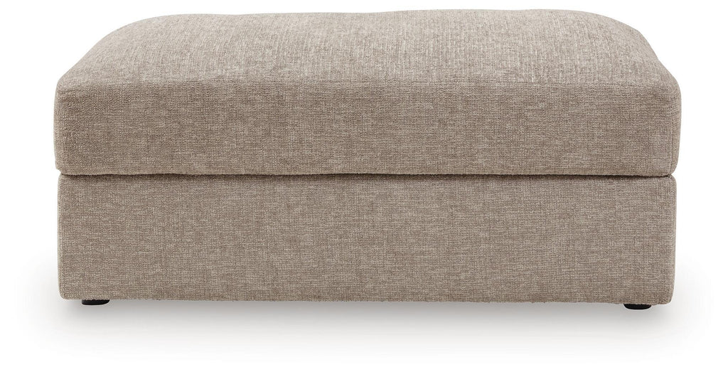 Oversized ottoman front view, rounded top, burlap-style beige upholstery and low legs