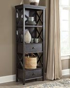 Dark gray display cabinet with open shelves, X-frame sides, and three drawers