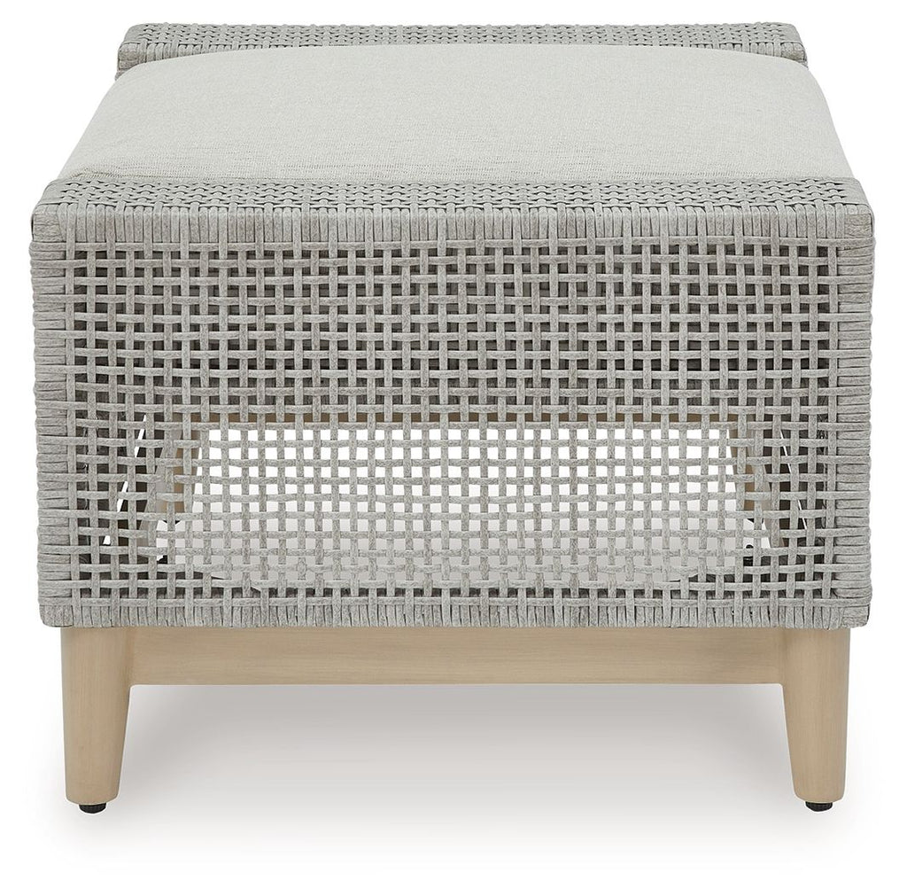Gray woven ottoman with tufted-look backless cushion on light wood legs