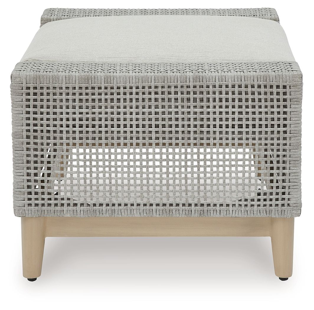 Gray woven ottoman with tufted-look backless cushion on light wood legs