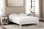 White platform bed with slatted base, paired posts, and fitted white mattress