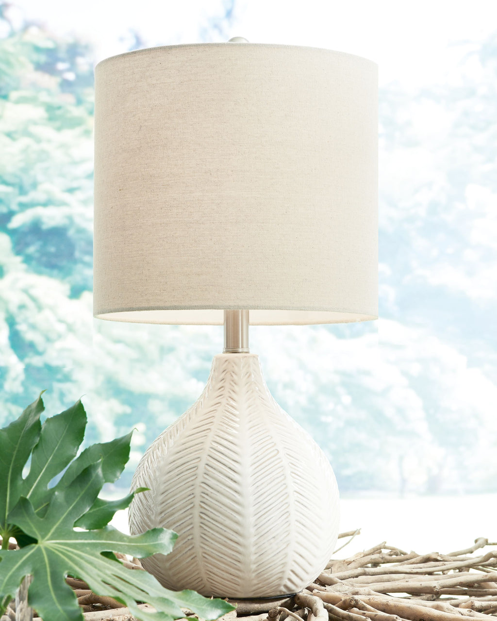 Ceramic table lamp with off-white drum shade and off-white ceramic teardrop body