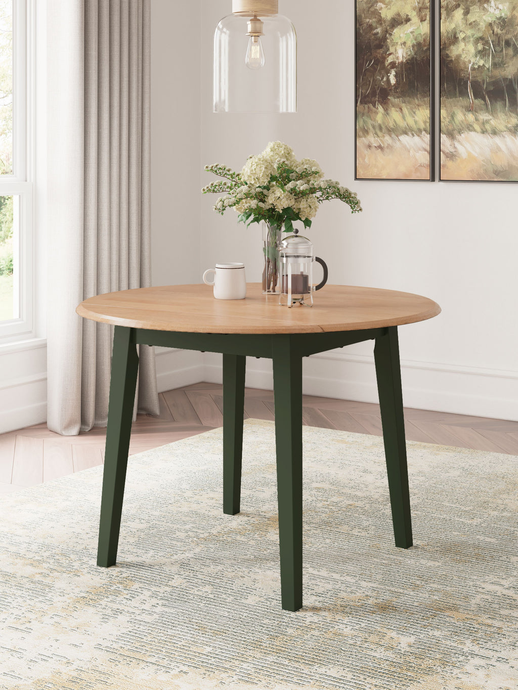 Round drop-leaf dining table with light wood top and green legs