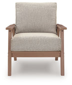 Front view lounge chair with light beige cushioned seat and back on driftwood frame