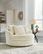 Beige oversized swivel accent chair with ribbed upholstery and rounded arms