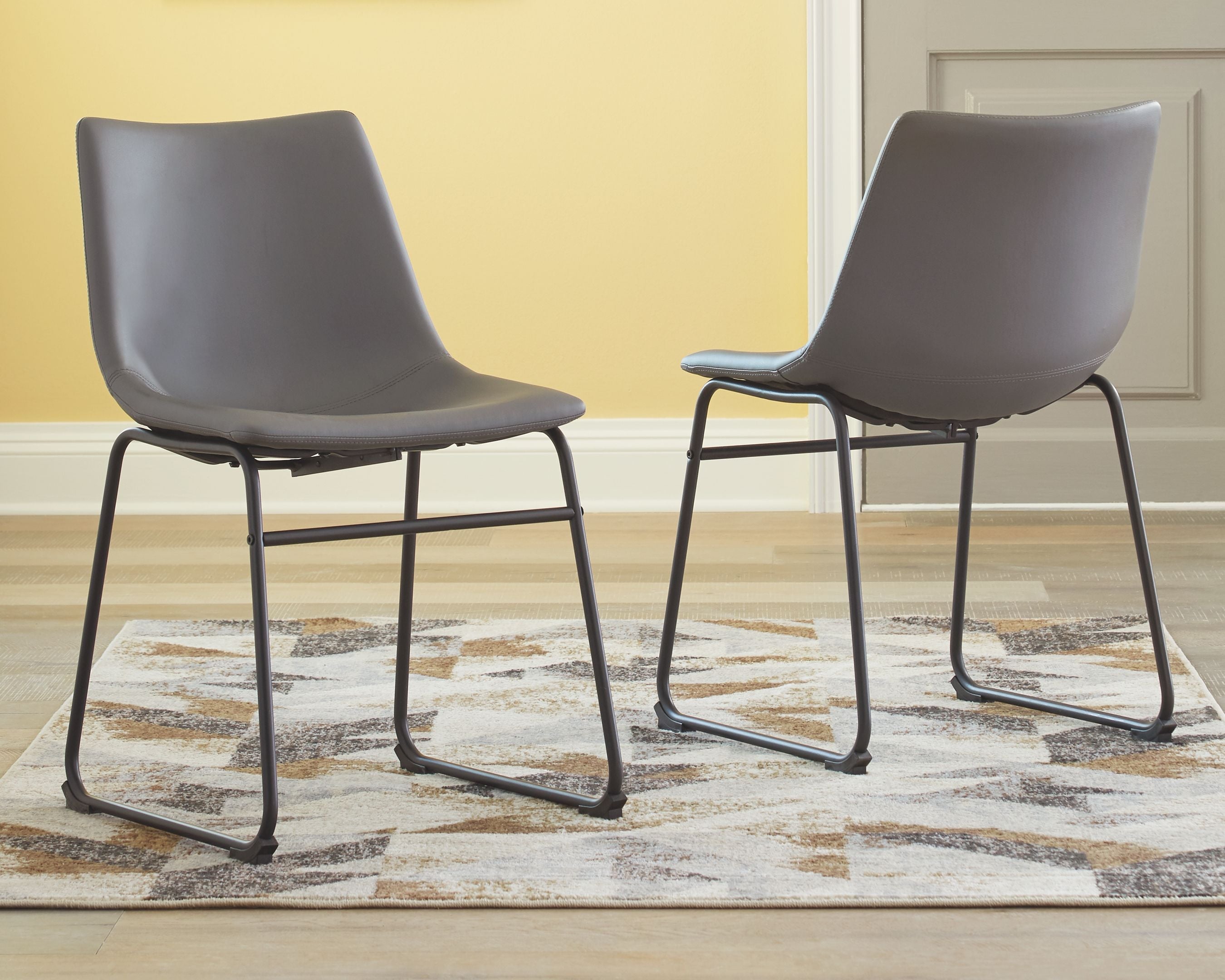 Set of gray upholstered side chairs with black metal frames