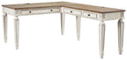 L-shaped home office desk with light wood top, white base, and drawer fronts