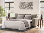 Gray queen sofa sleeper with open bed, gray throw, and four square pillows