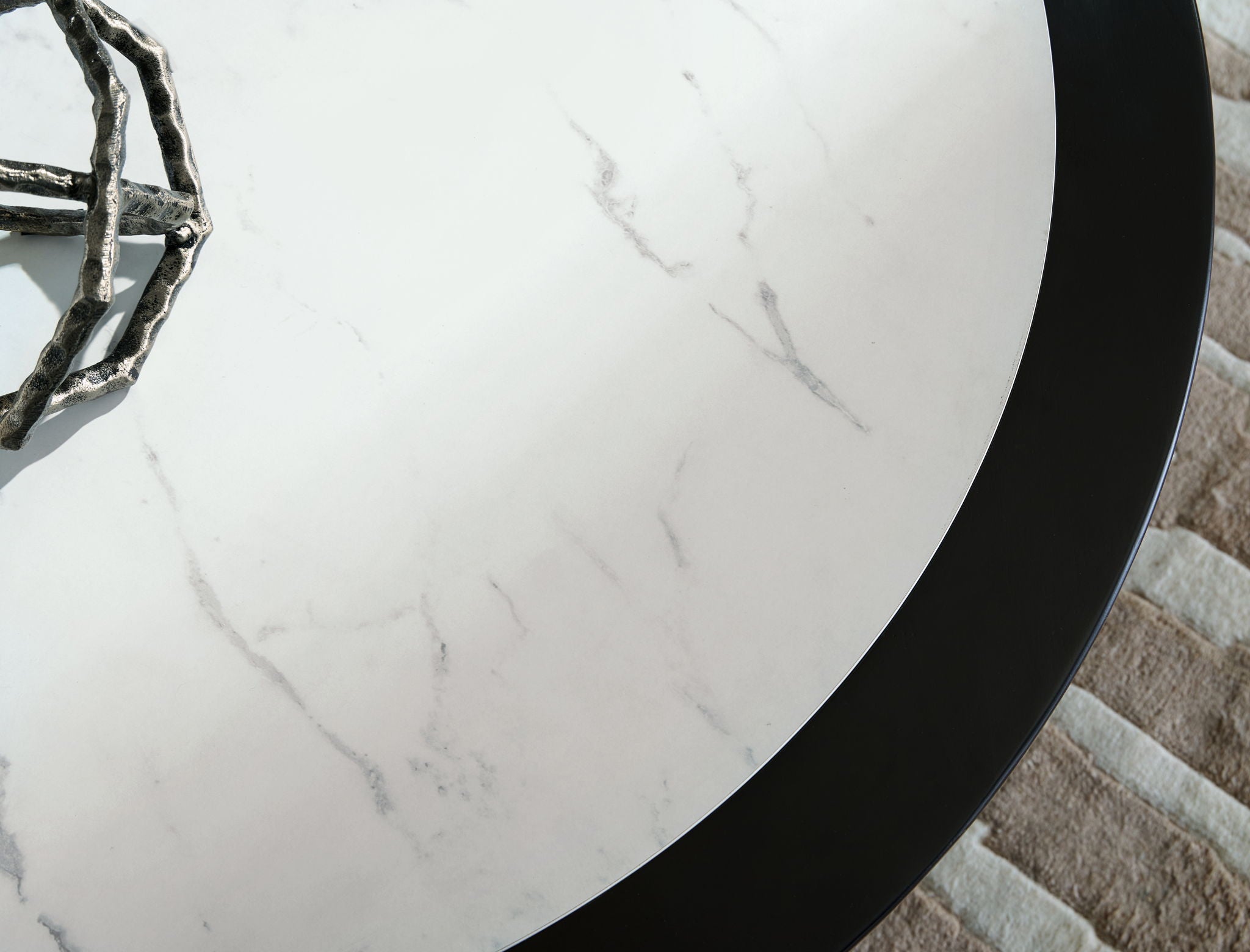 White marble-look table top with gray veining and black outer edge