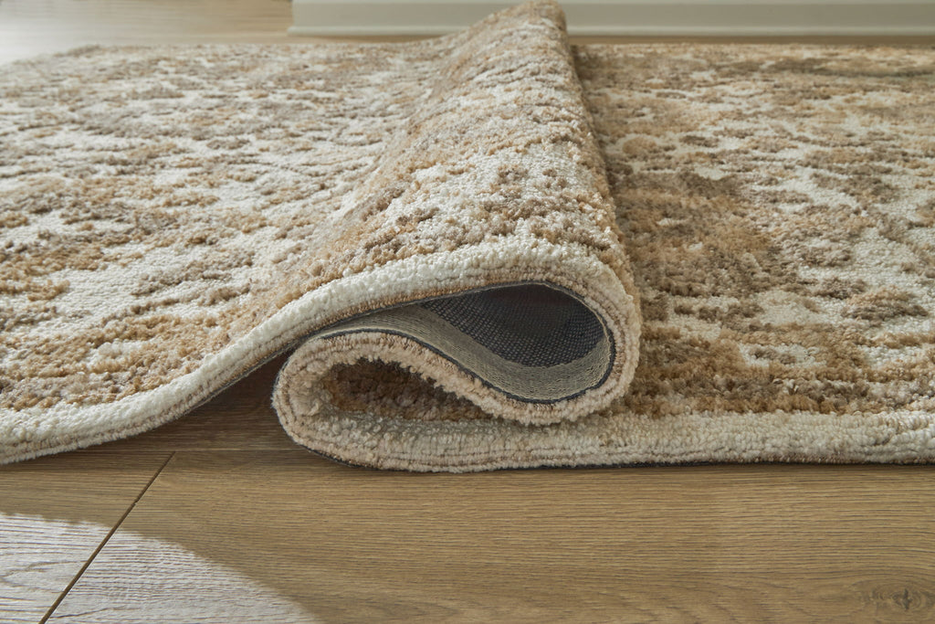 Light brown patterned area rug with cut-pile texture and rounded edge