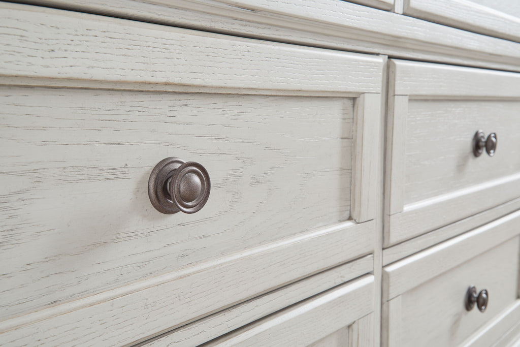 Antique white dresser drawer with round metal knob and wood grain texture