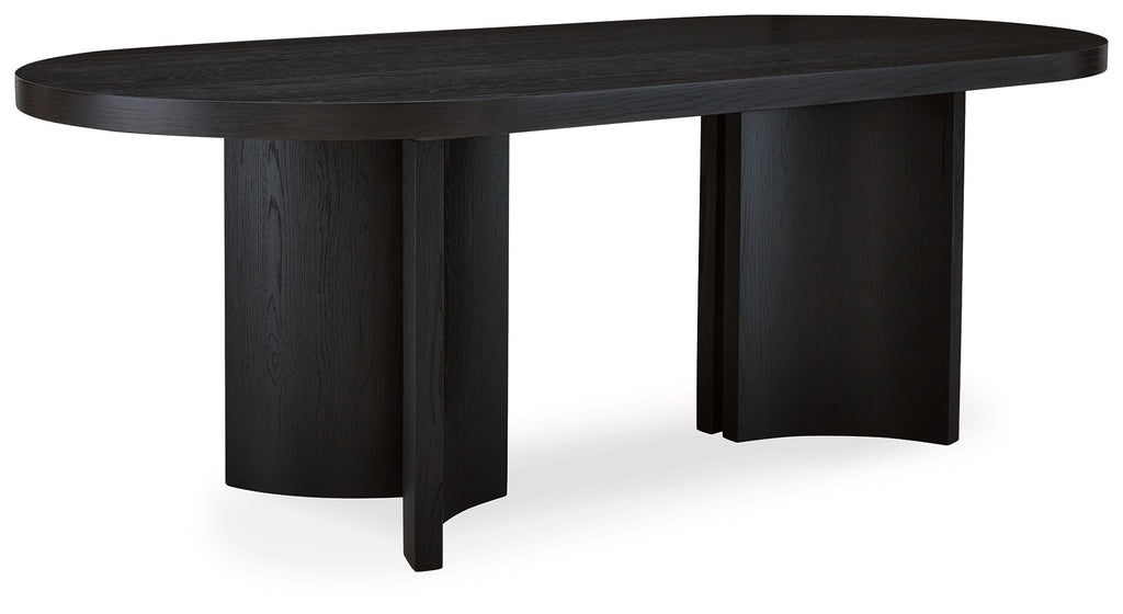 Black oval dining room table with thick tabletop and four pedestal-style legs