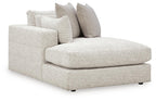 Corner chaise sofa with light textured fabric and two throw pillows, L-shaped design