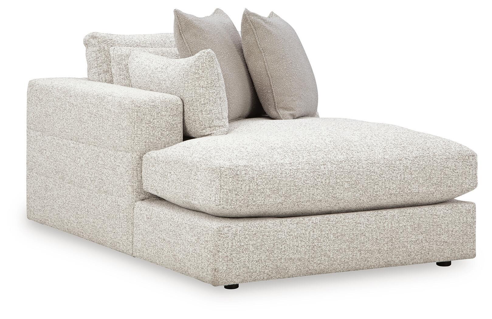 Corner chaise sofa with light textured fabric and two throw pillows, L-shaped design