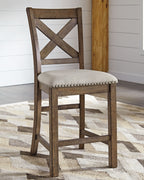 Counter height barstool with dark wood X-back and beige upholstered seat, nailhead trim