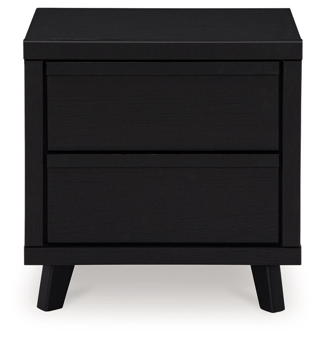 Black two-drawer night stand with two stacked drawer fronts and dark legs
